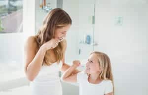Mother-and-Daughter-brushing-their-Teeth