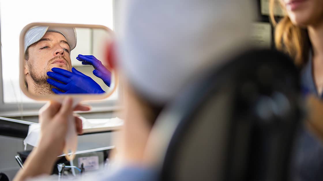 Pointing to the temporomandibular joint (TMJ) on a model school