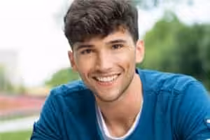 Smiling Young Man in Blue Shirt