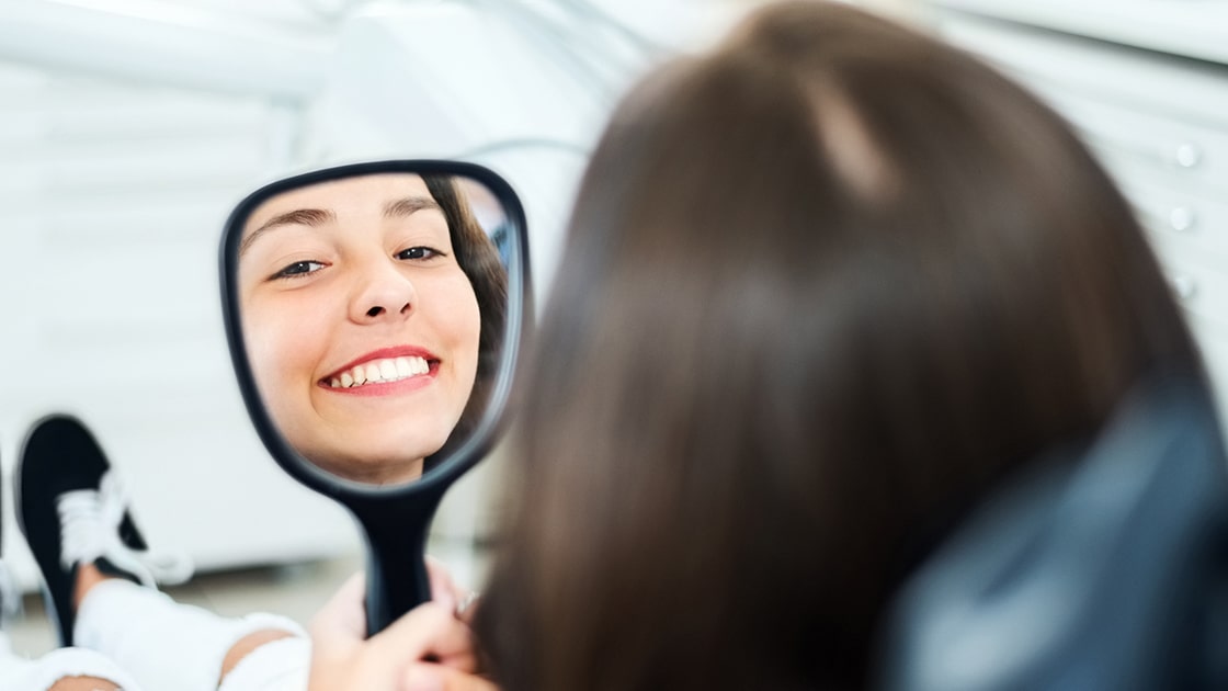 Woman Smiling in Mirror