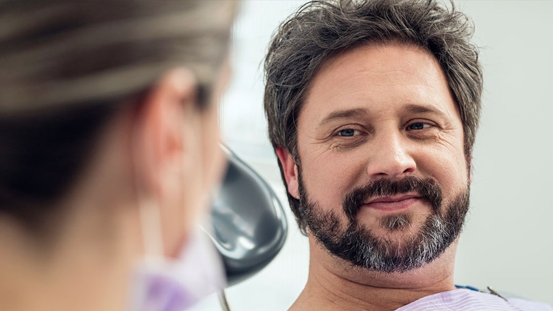Man Consulting with Dentist 