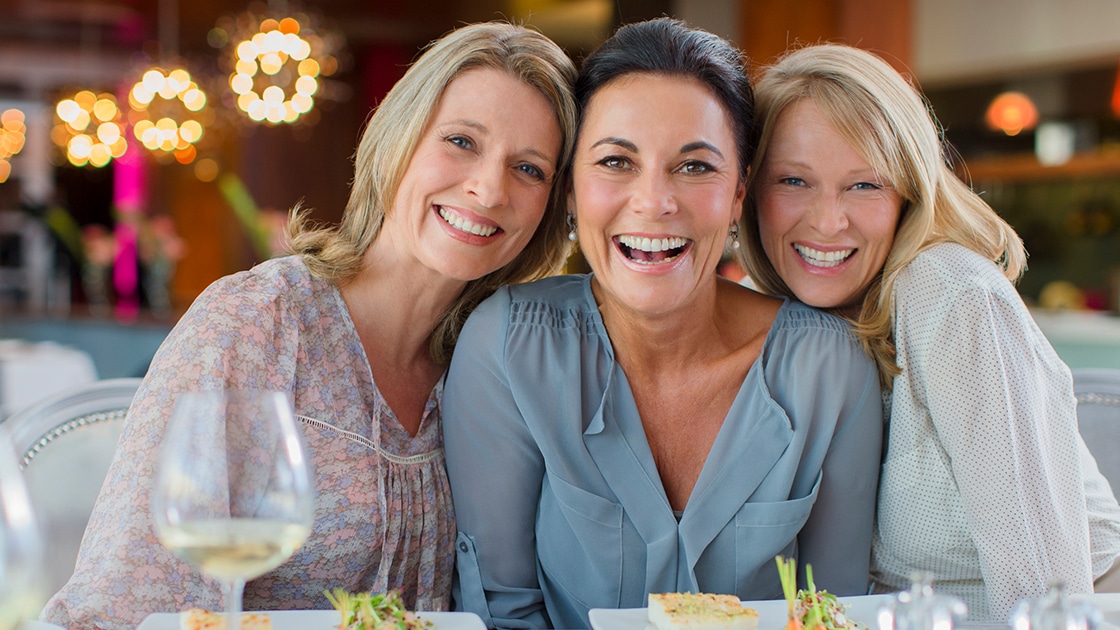 Smiling Women at Dinner